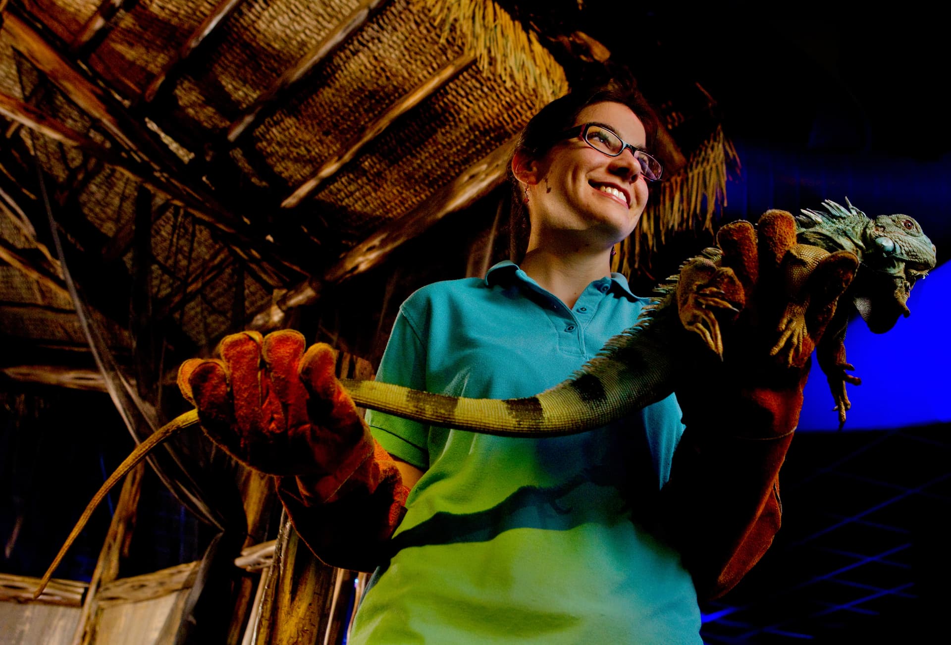 Educator holding an iguana