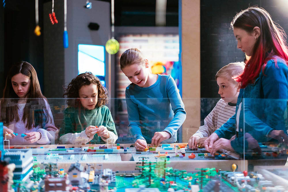 Kids building together at a LEGO table